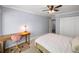 Bedroom features neutral colors, desk, ceiling fan and double door closet at 2102 Palmyra Se Dr, Marietta, GA 30067