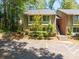 Two-story townhome with light green siding, parking in front, and a small garden at 2102 Palmyra Se Dr, Marietta, GA 30067
