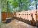 Enclosed patio features wood privacy fence, concrete pad and outdoor table, perfect for entertaining at 2102 Palmyra Se Dr, Marietta, GA 30067