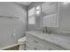 Bathroom featuring a single sink vanity with drawers for storage and a toilet next to it in a well-lit space at 4128 Boxwood Way, Duluth, GA 30096