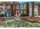 Charming brick townhome with colorful doors and well-maintained landscaping at 4128 Boxwood Way, Duluth, GA 30096
