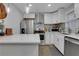 Bright kitchen featuring stainless steel appliances and a peninsula island at 4128 Boxwood Way, Duluth, GA 30096