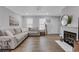 Bright living room with a marble fireplace, and a comfortable sectional sofa at 4128 Boxwood Way, Duluth, GA 30096