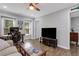 Spacious living room with ample natural light, complemented by a modern ceiling fan and sleek furniture arrangement at 4128 Boxwood Way, Duluth, GA 30096
