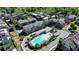 Aerial view of townhomes and pool nestled in a vibrant community with manicured landscaping at 6065 Cushing Cir, Norcross, GA 30071