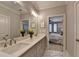 Luxurious bathroom with double sink vanity, marble countertops, tiled floors, and a glass-enclosed shower at 6065 Cushing Cir, Norcross, GA 30071