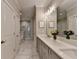 Luxurious bathroom with double sink vanity, marble countertops, tiled floors, and a glass-enclosed shower at 6065 Cushing Cir, Norcross, GA 30071