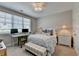 A cozy bedroom features a large window, a work station, and neutral tones for a soothing ambiance at 6065 Cushing Cir, Norcross, GA 30071