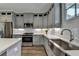Well-designed kitchen features stainless steel appliances, gray cabinets, quartz countertops, and hardwood floors at 6065 Cushing Cir, Norcross, GA 30071