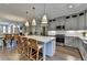 Open kitchen design features large island, stainless steel appliances, hardwood floors, and adjacent dining area at 6065 Cushing Cir, Norcross, GA 30071
