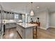 Spacious kitchen features gray cabinetry, stainless appliances, hardwood floors, and a large island at 6065 Cushing Cir, Norcross, GA 30071