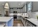 Kitchen features stainless steel appliances, gray cabinets, subway tile backsplash, and hardwood floors at 6065 Cushing Cir, Norcross, GA 30071