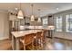 Modern kitchen boasts stainless steel appliances, gray cabinets, hardwood floors, and a center island at 6065 Cushing Cir, Norcross, GA 30071