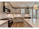 Stylish kitchen with stainless steel appliances, gray cabinets, island, and subway tile backsplash at 6065 Cushing Cir, Norcross, GA 30071