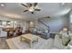Open-concept living room features hardwood floors, ceiling fan, neutral decor, and staircase to the second floor at 6065 Cushing Cir, Norcross, GA 30071