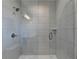 Sleek shower featuring gray-scale tile, frameless glass door and shower head at 6065 Cushing Cir, Norcross, GA 30071