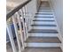 Elegant staircase with wood treads, white risers, and white railings leading to the upper level at 6065 Cushing Cir, Norcross, GA 30071