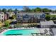 Charming townhomes overlook a pool with lounge chairs, pergola, and a pool house at 6065 Cushing Cir, Norcross, GA 30071