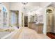 Luxurious bathroom featuring a soaking tub, walk-in shower, and granite countertops at 841 Camden Park Ne Ct, Atlanta, GA 30342