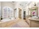 Beautiful bathroom features a tub, shower, walk-in closet, and tile flooring at 841 Camden Park Ne Ct, Atlanta, GA 30342