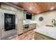 Butler Pantry with stainless steel fridge, granite countertops and copper ceiling at 841 Camden Park Ne Ct, Atlanta, GA 30342