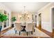 Formal dining room featuring a chandelier, decorative wallpaper, and ample natural light at 841 Camden Park Ne Ct, Atlanta, GA 30342