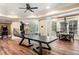 Spacious game room features a ping pong table, arcade game and hardwood floors at 841 Camden Park Ne Ct, Atlanta, GA 30342