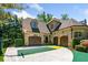 Three-car garage with a basketball court and well-maintained landscaping at 841 Camden Park Ne Ct, Atlanta, GA 30342