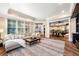 Bright living room with hardwood floors, large windows, and views into the game room at 841 Camden Park Ne Ct, Atlanta, GA 30342