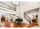 Open floor plan showcases a piano, staircase, chandelier, and hardwood floors at 841 Camden Park Ne Ct, Atlanta, GA 30342