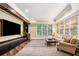 Comfortable living room features hardwood floors, large windows, and custom built-ins at 841 Camden Park Ne Ct, Atlanta, GA 30342