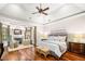 Cozy primary bedroom featuring a fireplace, hardwood floors, and vaulted ceilings at 841 Camden Park Ne Ct, Atlanta, GA 30342