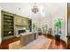 Bright office with custom built-ins, a fireplace, and large windows offering lots of natural light at 841 Camden Park Ne Ct, Atlanta, GA 30342