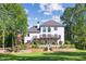 Expansive backyard featuring a stone patio, lush lawn, well manicured garden beds, and a relaxing deck overlooking the landscape at 900 Crossfire Nw Rdg, Marietta, GA 30064