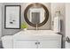 Bathroom featuring a white vanity with a round mirror and a framed picture at 900 Crossfire Nw Rdg, Marietta, GA 30064