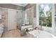 Luxurious bathroom featuring marble tile, a soaking tub with a tray, and a glass-enclosed shower at 900 Crossfire Nw Rdg, Marietta, GA 30064