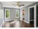 A bright bedroom with two windows, a ceiling fan, hardwood floors, and an ensuite bathroom, offering a comfortable retreat at 900 Crossfire Nw Rdg, Marietta, GA 30064