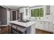 Bright kitchen featuring white cabinets, stainless steel appliances, and a center island with barstool seating at 900 Crossfire Nw Rdg, Marietta, GA 30064