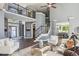 An open floor plan features a two-story living room with a fireplace, stairs, and dark hardwood floors at 900 Crossfire Nw Rdg, Marietta, GA 30064
