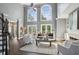 Bright living room boasts soaring ceilings, large windows, fireplace, and hardwood floors at 900 Crossfire Nw Rdg, Marietta, GA 30064