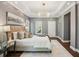 Serene main bedroom with tray ceiling, chandelier, neutral decor, and ample natural light at 900 Crossfire Nw Rdg, Marietta, GA 30064