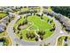 Aerial view of landscaped community park with walking paths and lush green space surrounded by neighborhood homes at 2315 Saddle Brook Trce, Cumming, GA 30040