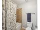 Bathroom featuring a tiled shower, a toilet and towel rack at 2315 Saddle Brook Trce, Cumming, GA 30040