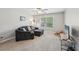 A cozy bedroom features neutral carpet, a comfortable sofa, and a window providing natural light at 2315 Saddle Brook Trce, Cumming, GA 30040