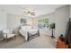 Inviting bedroom with a large window, chair, and neutral colored carpet at 2315 Saddle Brook Trce, Cumming, GA 30040