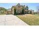 Charming two-story brick home featuring a driveway and well-maintained lawn at 2315 Saddle Brook Trce, Cumming, GA 30040