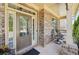 Cozy front porch with brick facade, columns and chairs, offering a relaxing outdoor space at 2315 Saddle Brook Trce, Cumming, GA 30040