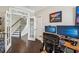 Home office with hardwood floors, desk, and staircase just outside at 2315 Saddle Brook Trce, Cumming, GA 30040