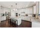 Well-appointed kitchen features an island with seating, granite countertops, and stainless steel appliances at 2315 Saddle Brook Trce, Cumming, GA 30040