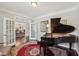 Beautiful living room featuring a piano, hardwood floors, and open concept design at 2315 Saddle Brook Trce, Cumming, GA 30040